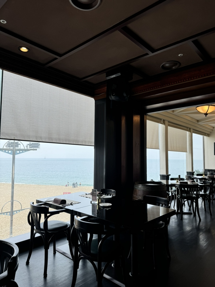 Floor-to-ceiling window with Haeundae beach view at O’Kim’s