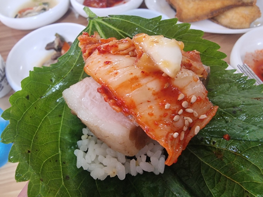 Bossam ssam wrap with perilla lettuce pork and kimchi