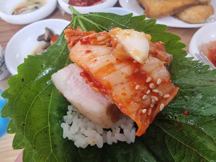 Bossam ssam wrap with perilla lettuce pork and kimchi