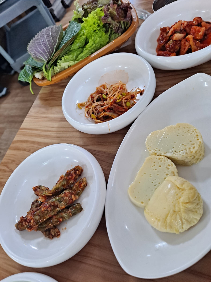 Steamed Korean egg gyeranjjim with assorted braised side dishes