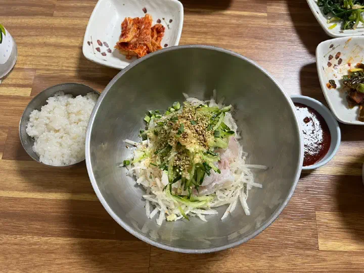 Hoeguksu noodles topped with cucumber, served with anchovy broth