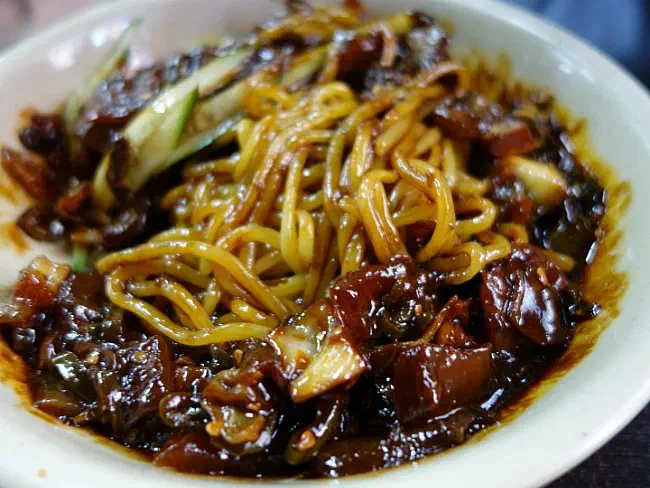 Mixed gochu-ganjjajang with chunks of pork, onion and cucumber