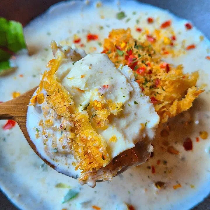 Close-up of crispy fried tofu coated in creamy fermented crab sauce