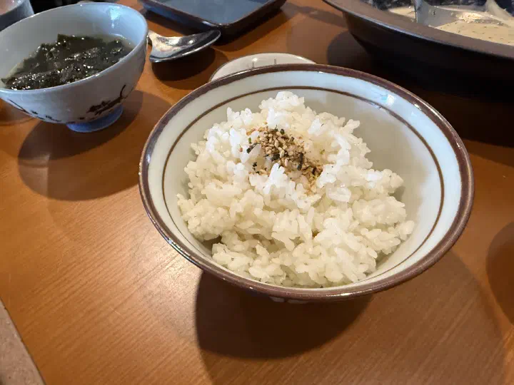 Bowl of steamed rice with sesame seasoning and a side of Korean seaweed soup