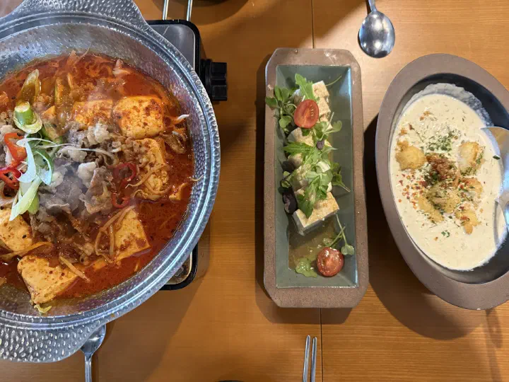 Full table spread of chadol dubu jorim, tofu salad, and gani miso cream tofu at Food Gallery Bean