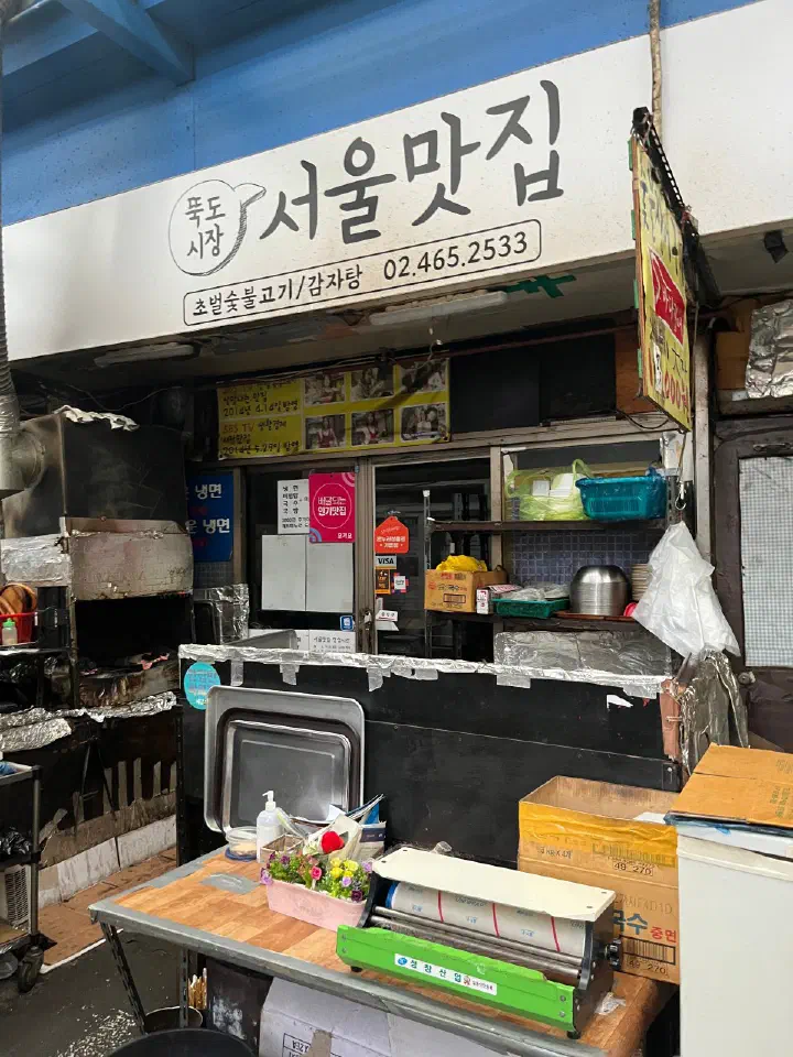 Charcoal brazier set out in the alley in front of the Seoul Matzip storefront