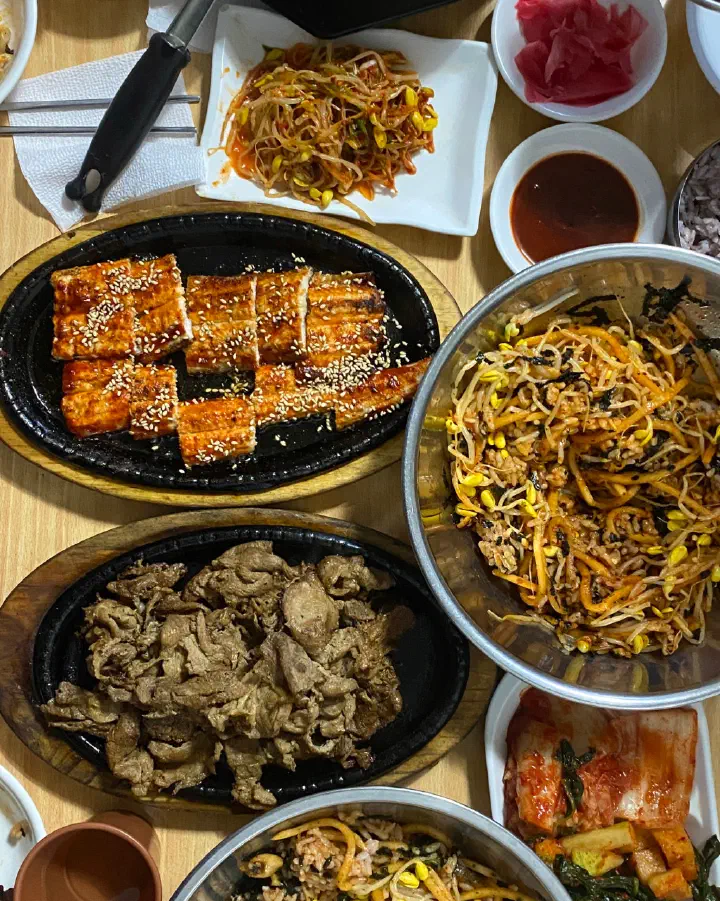 Full Seoul Matzip table with charcoal pork, grilled eel, bibimbap and Korean side dishes