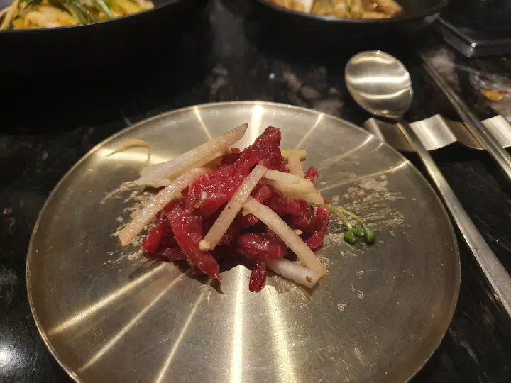 Staff grilling and tearing the beef at Changgo43 Pangyo