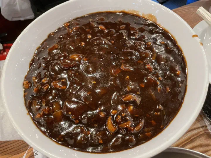 Close-up of Yeonghwaru gochu-ganjjajang sauce with chunks of pork and onion