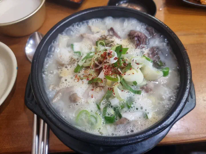 Sundaeguk with dadaegi spicy paste stirred in, turning the broth reddish