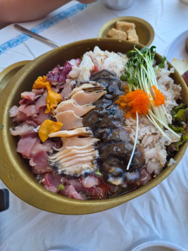Hae-jeon mulhoe at Chungchosoo Mulhoe Sokcho, topped with live abalone, sea cucumber and sea squirt