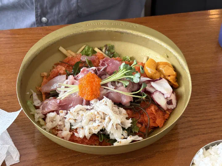 Signature Chungchosoo mulhoe in Sokcho, sashimi sea urchin and flying fish roe over icy beef bone broth