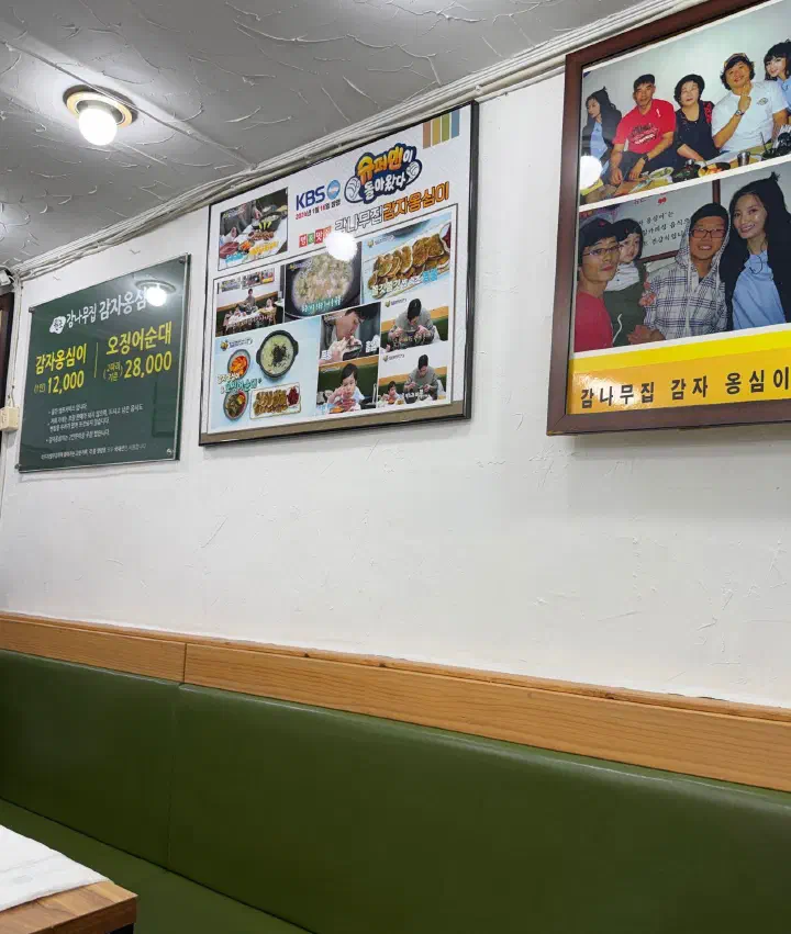 감나무집감자옹심이 벽면의 방송 출연 사진과 연예인 방문 기념 액자