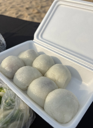 A box of Yukgu Bangatgan chapssal mochi opened on the beach in Sokcho