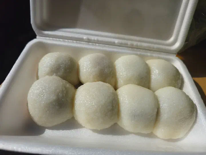 A takeout box of eight Yukgu Bangatgan chapssal mochi before being split up for the freezer