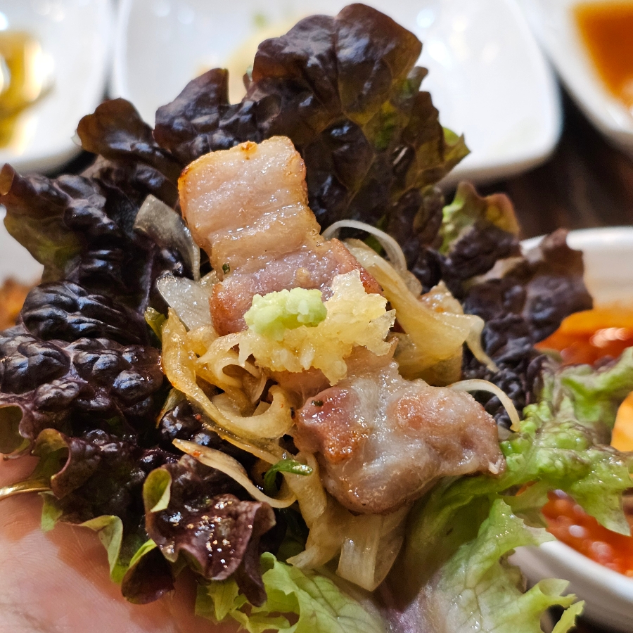 Korean ssam lettuce wrap with pork and green onion salad