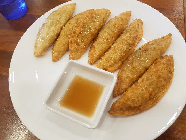 Tonkatsu served with dipping sauce on the side at Bonyeoubonjeong