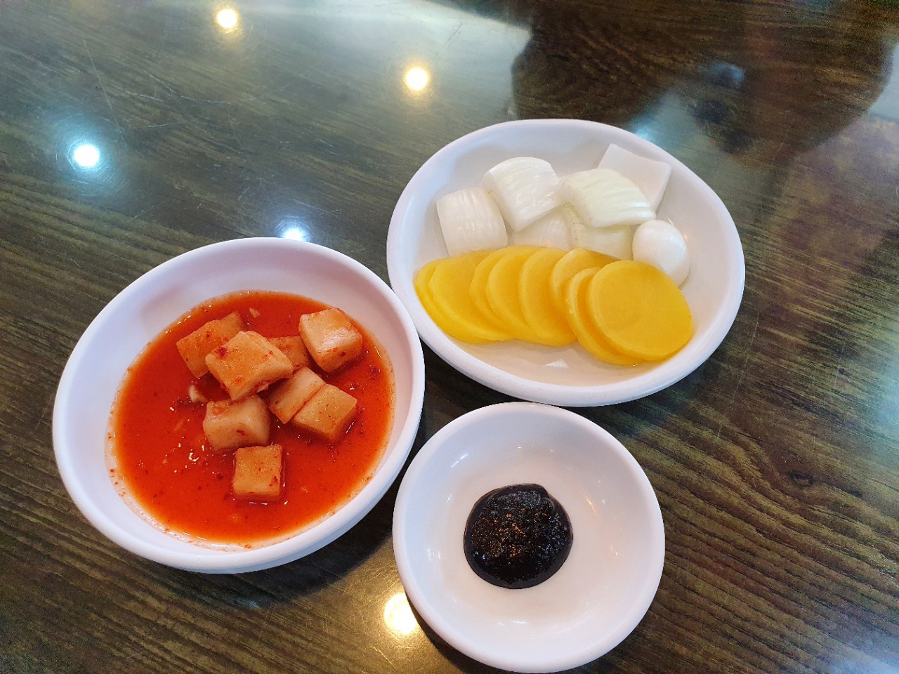 Side dishes at Donghaebanjeom: pickled radish, onion, and black bean sauce