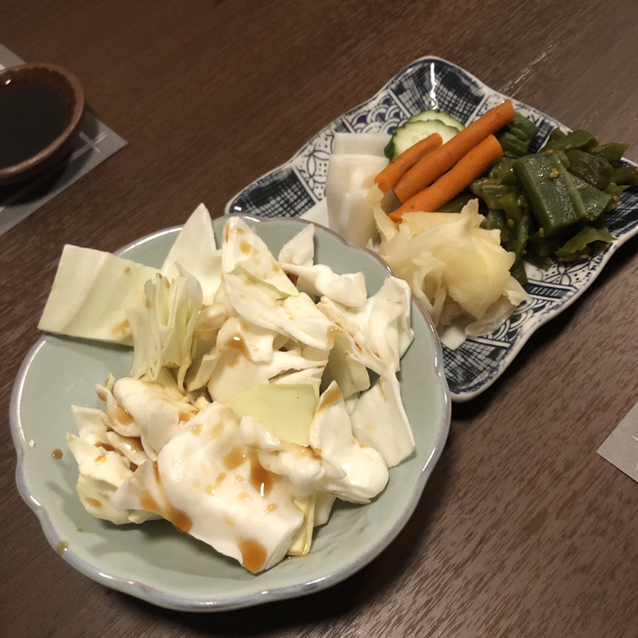Cabbage salad and Korean pickles served as banchan