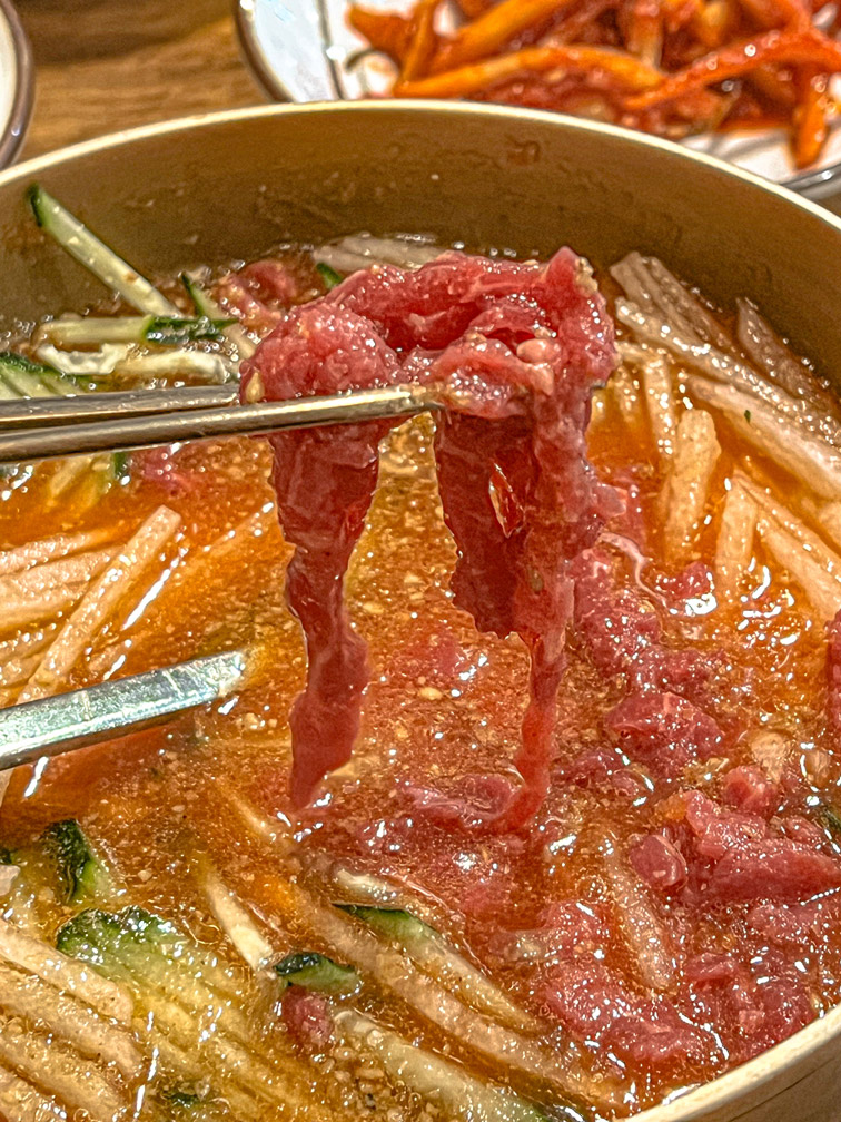 Close-up of fresh hanwoo yukhoe with chopsticks