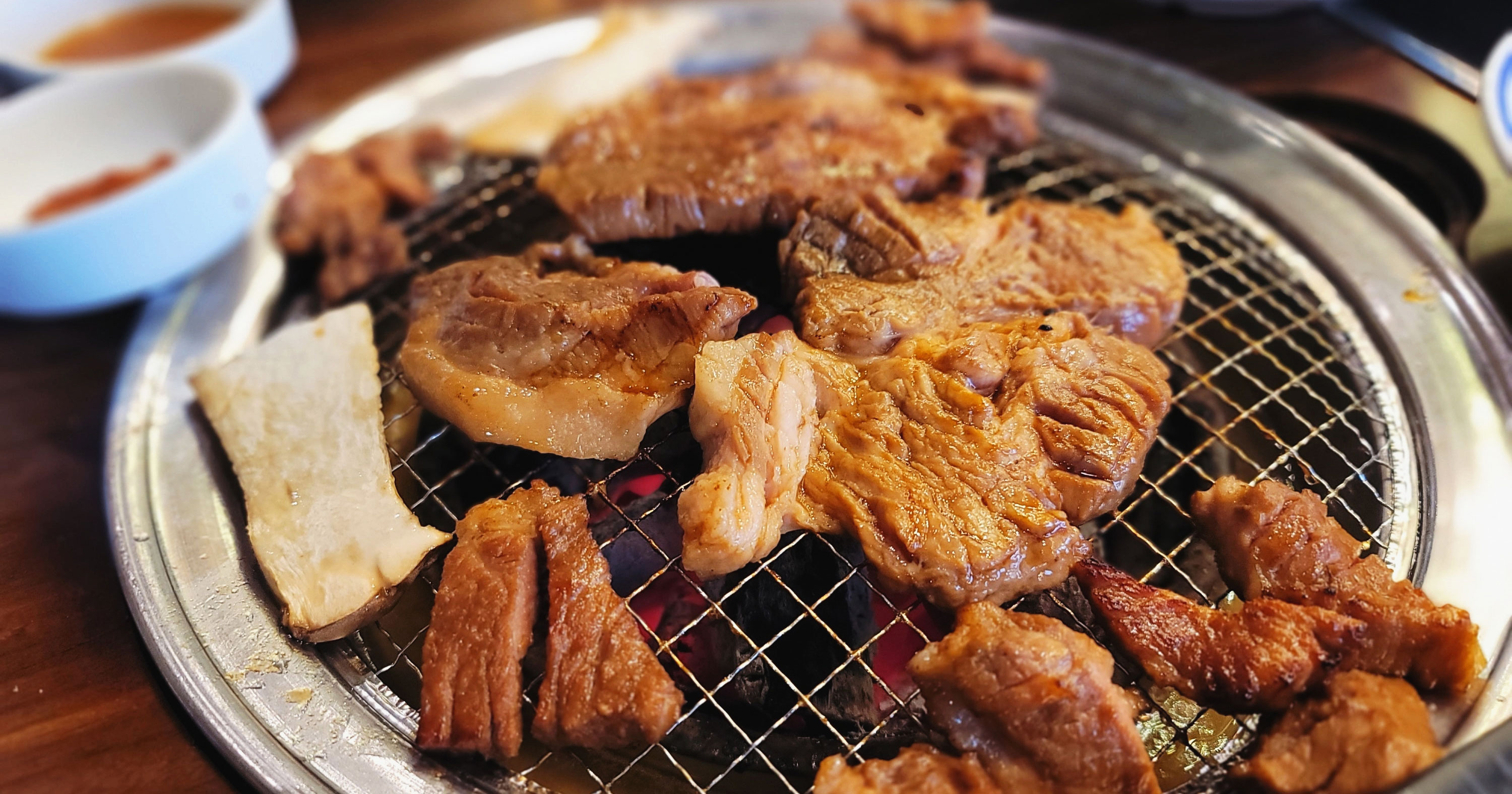 Marinated beef galbi grilling over charcoal at Hangawi in Ulsan