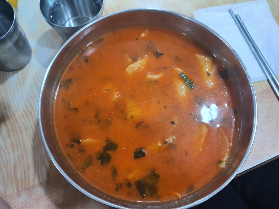 Overhead view of the spicy broth showing sancho dust and chopped bangah leaves