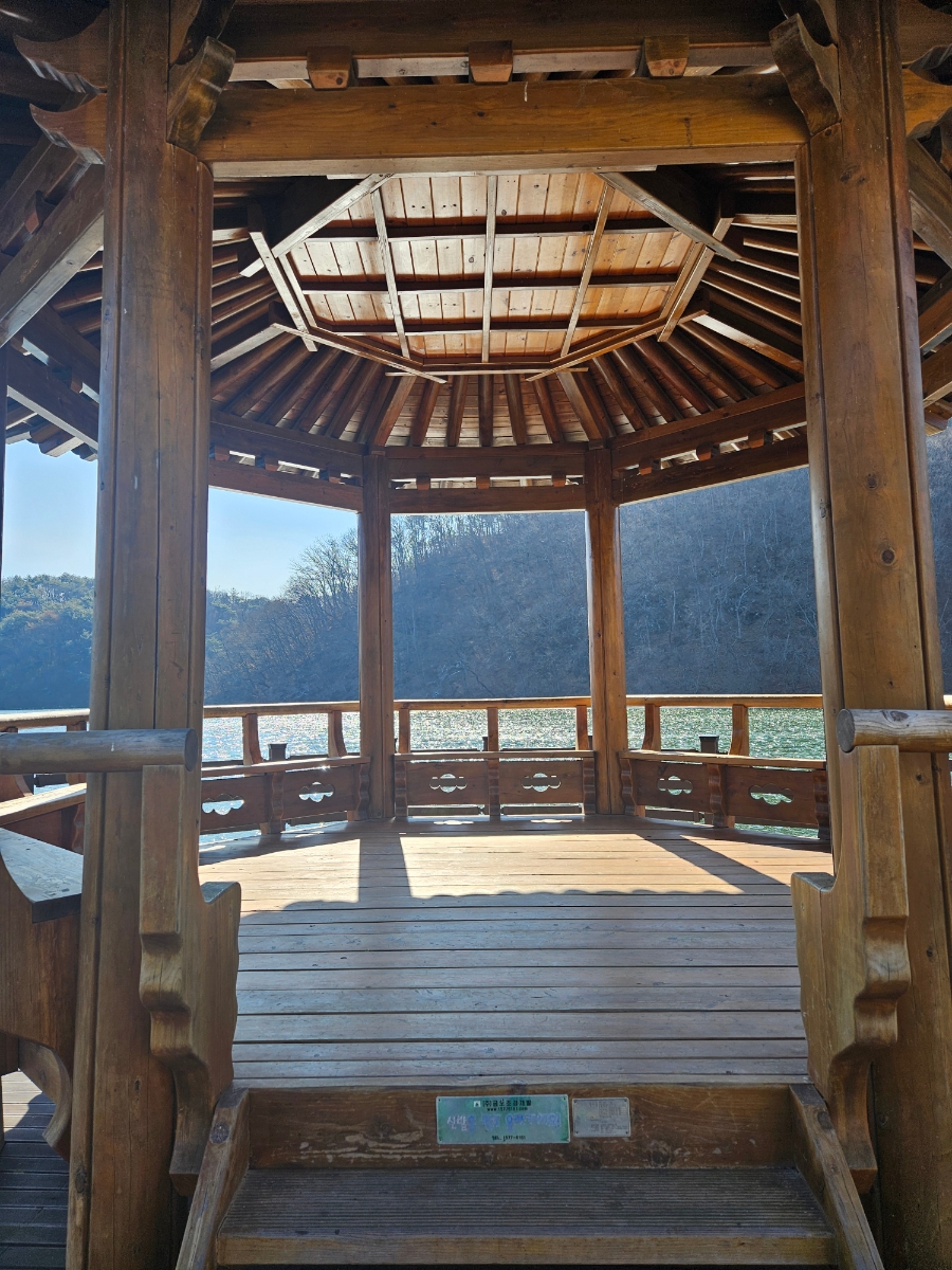 Inside view of the wooden Korean pavilion looking out over the reservoir