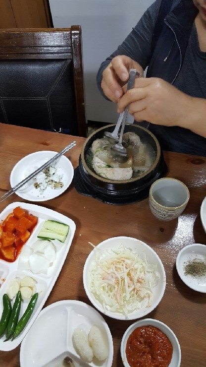 A bubbling stone pot and the side dishes at Gogung Samgyetang