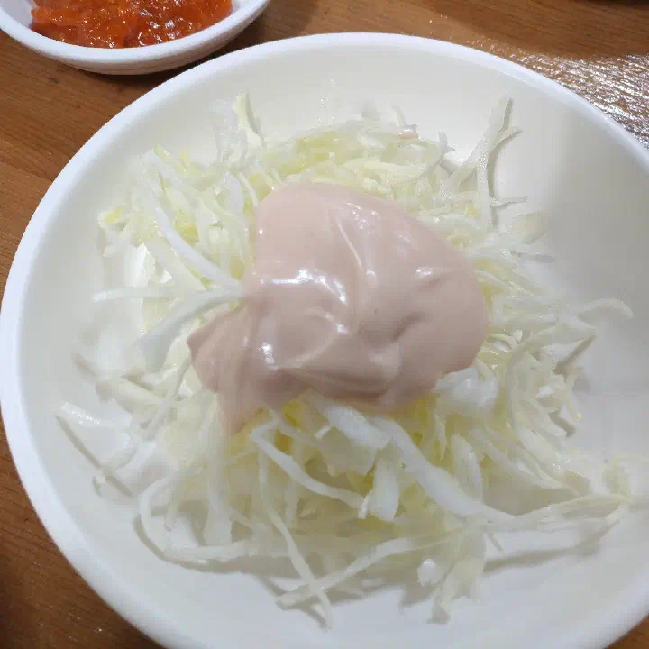 A cabbage salad and quail eggs among the side dishes at Gogung Samgyetang