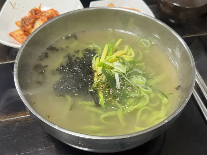 A bowl of chive kalguksu at Joseon Kalguksu