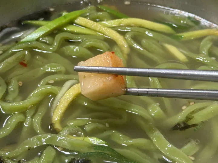 Lifting the chive noodles at Joseon Kalguksu