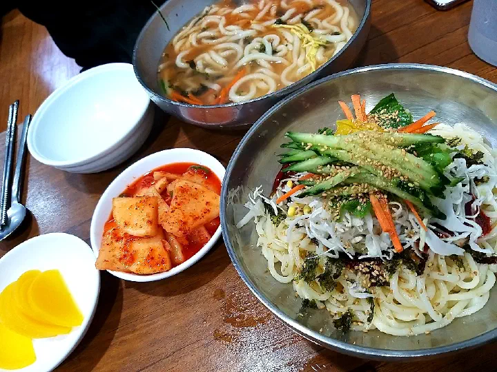Bibim kalguksu piled with cabbage on the table