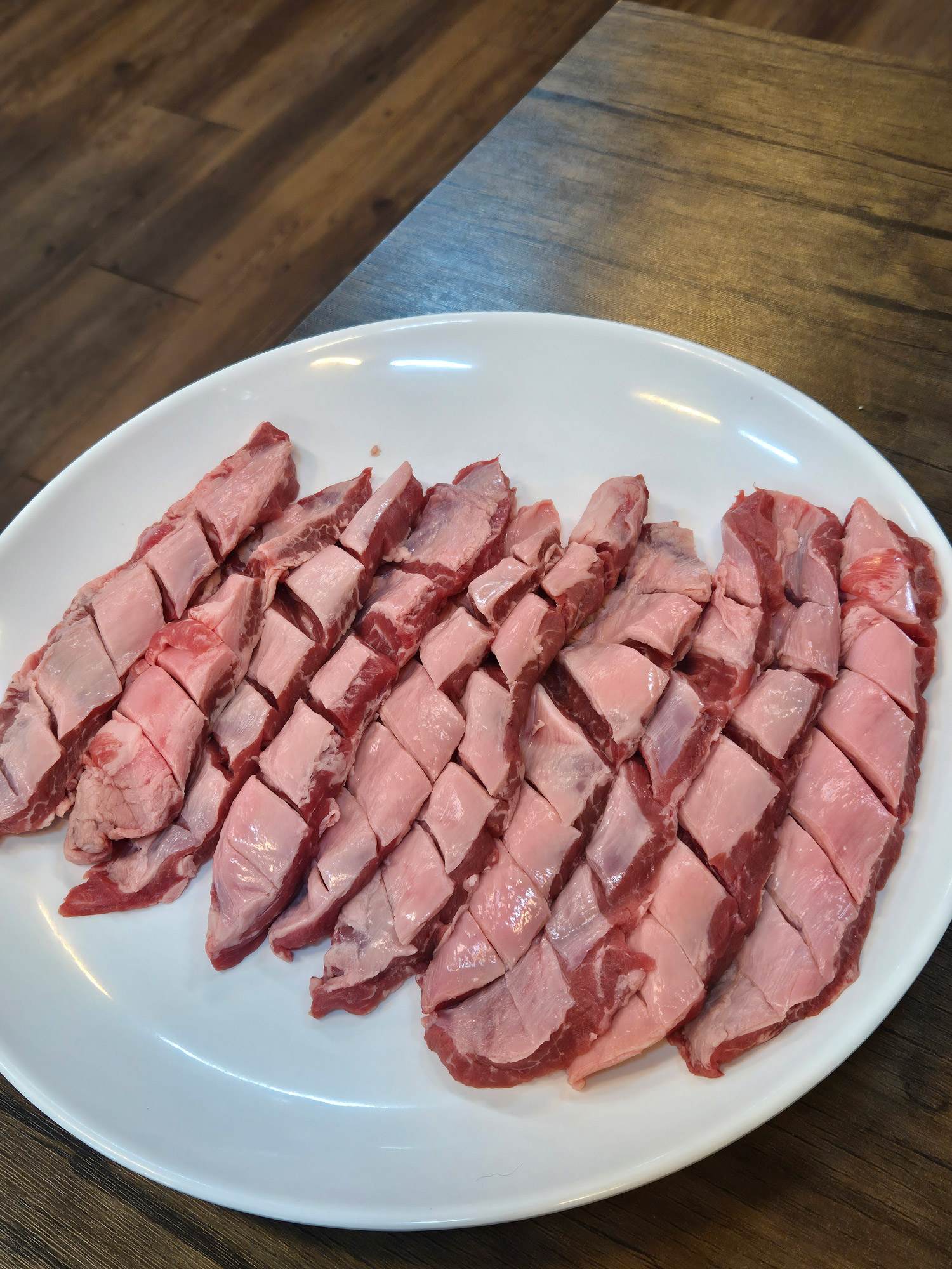 Close-up of fresh, scored galmaegisal strips