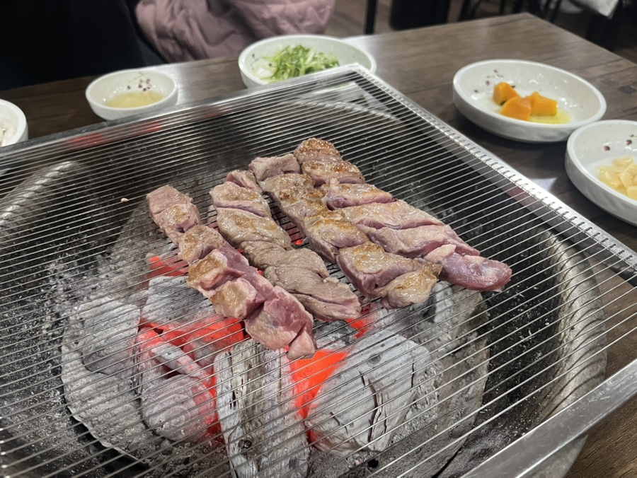 Galmaegisal strips grilling over the charcoal