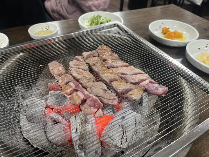 Galmaegisal strips grilling over the charcoal