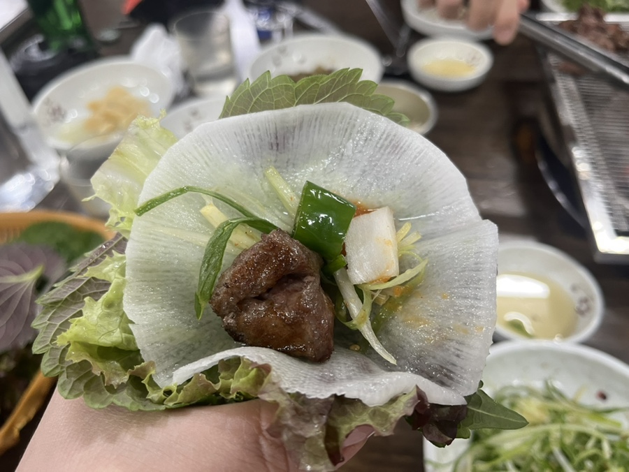 Galmaegisal wrapped in pickled radish disc with scallion