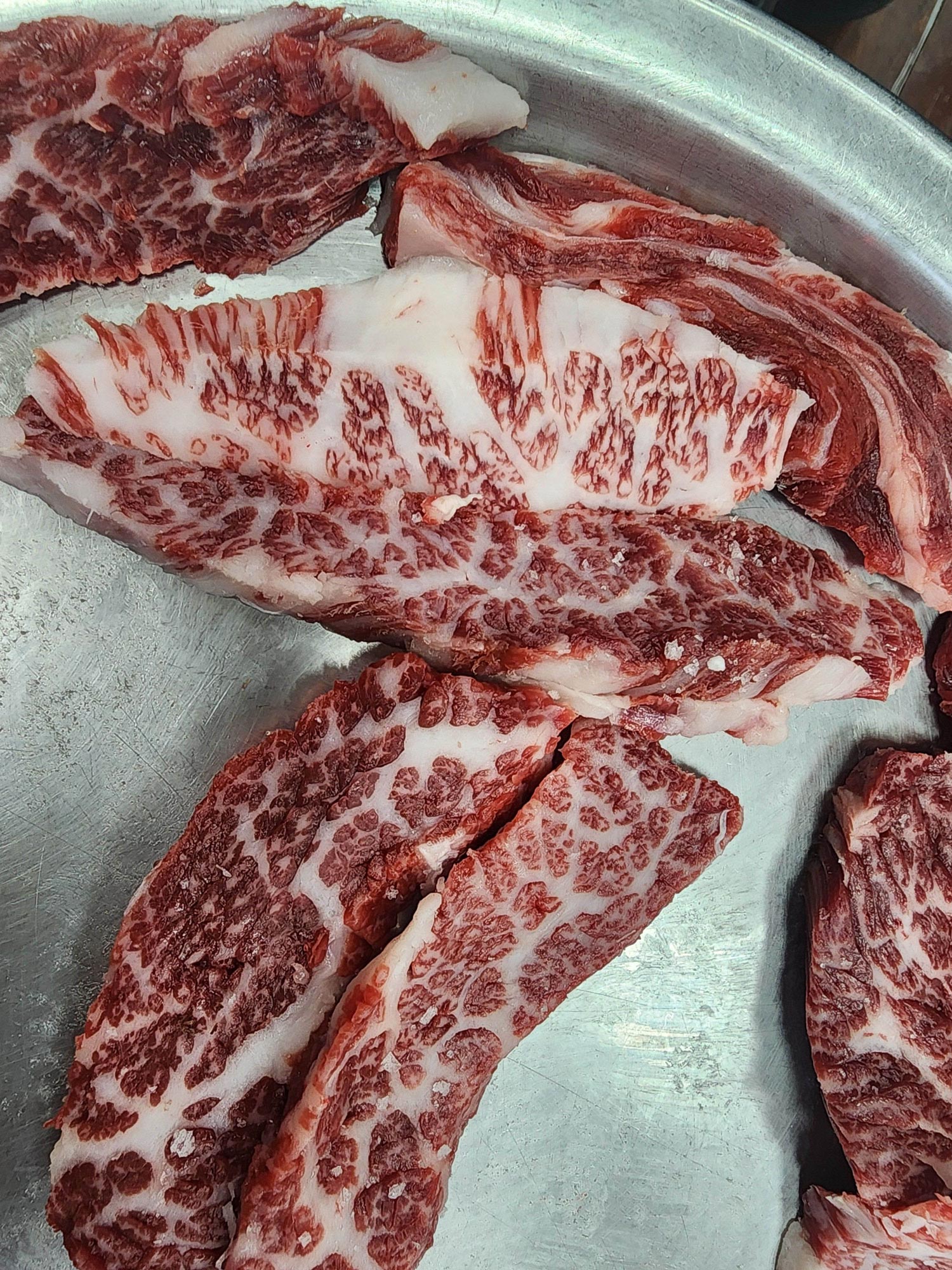 Close-up of Hanwoo galbisal marbling, premium Korean beef short rib