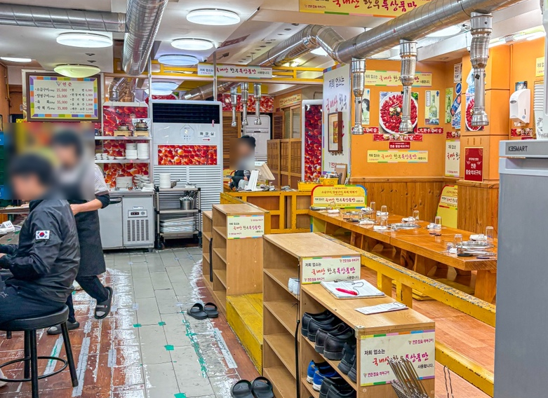 Inside the dining room at Yeonchun, with low tables and traditional grill setup