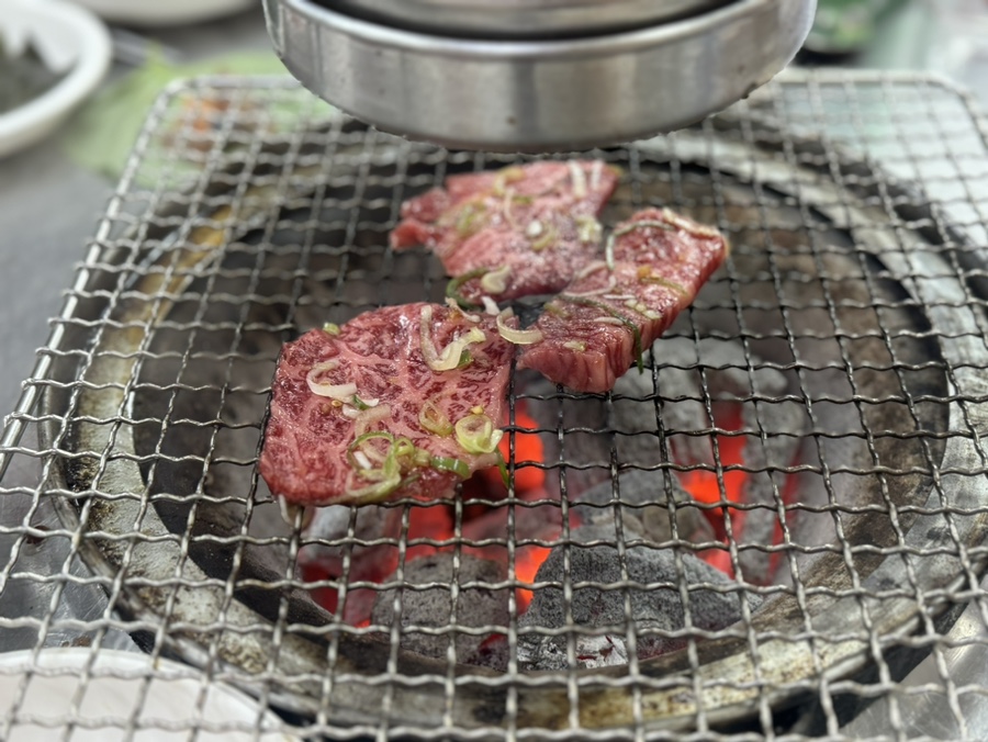 Marinated Hanwoo galbisal cooking over charcoal at Yeonchun