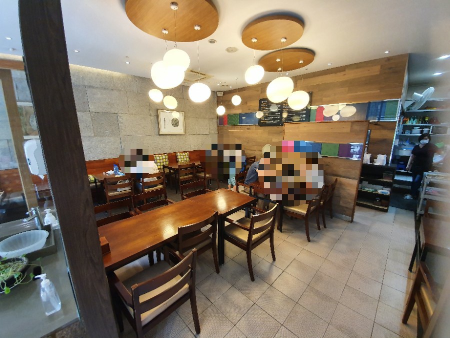 Clean interior dining area with round pendant lights at Wonjo Jeonbokjuk
