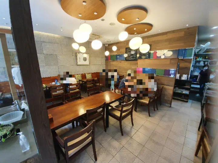 Clean interior dining area with round pendant lights at Wonjo Jeonbokjuk