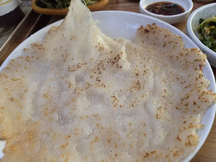 Close-up of the lacy crisp edge and chewy centre of the potato pancake
