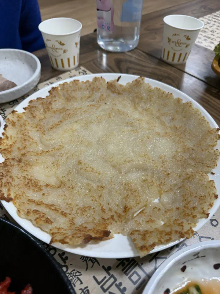 Whole Gangwon-style gamjajeon potato pancake filling the plate