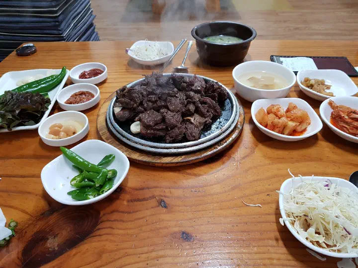 A spread of beef ribs and assorted banchan at Sobok Galbi