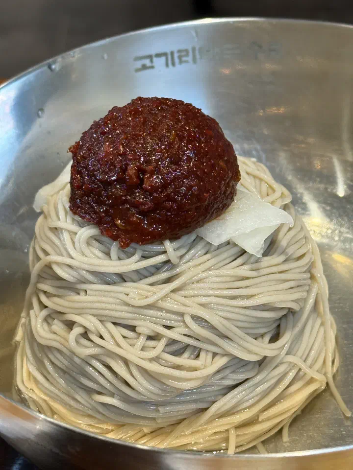 Bowl of spicy bibim makguksu ordered as a 6,000 won add-on at Gogiri Makguksu