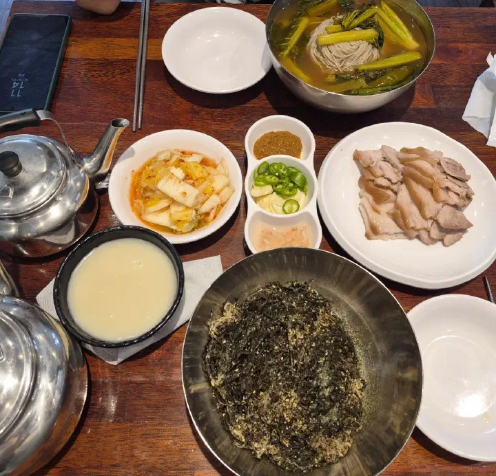 Full table at Gogiri Makguksu with summer yeolmu kimchi makguksu, suyuk, kimchi and perilla oil noodles