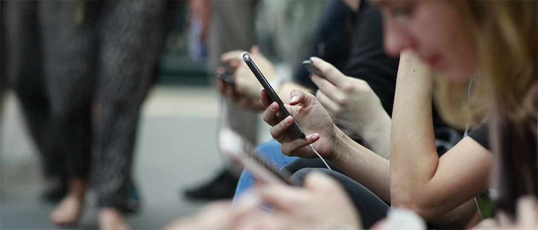 People focused on their smartphones, a common scene of social media usage