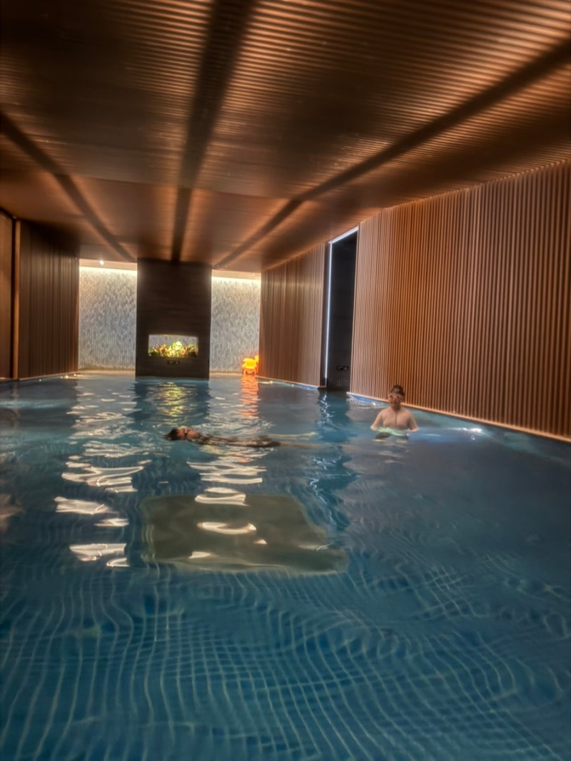 Indoor media pool with warm wood-toned interior at Ananti Cove Water House