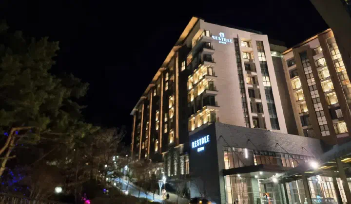 The Restri Resom building at Forest Resom glowing at night