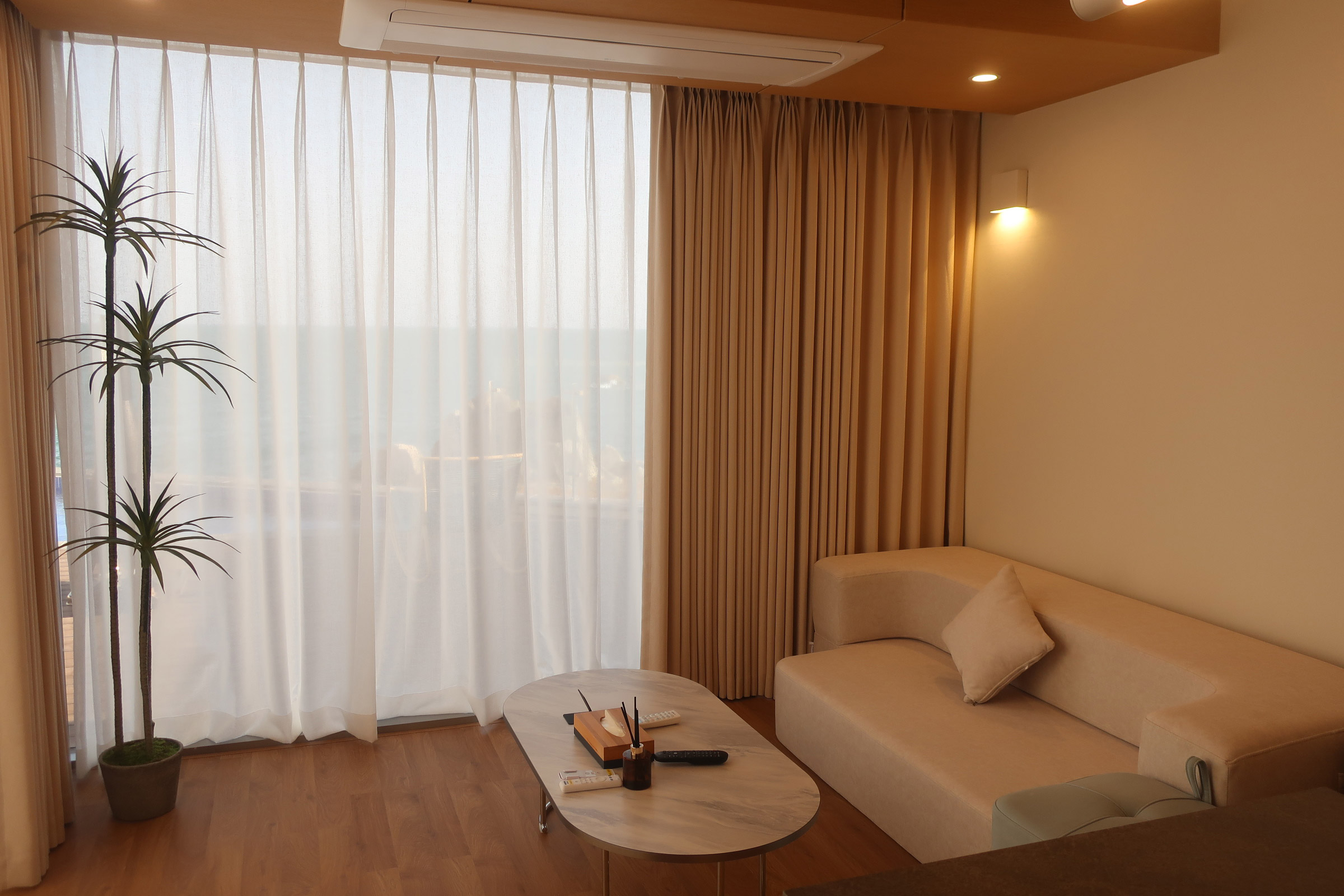 Ocean Bliss villa living room - warm wood interior with projector